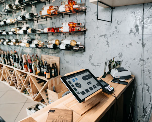 A tablet POS system on a stand in a wine shop and bar